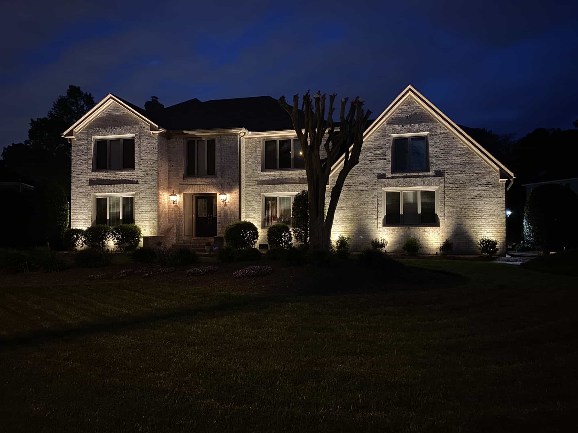 outdoor illuminating lights on a home at night 